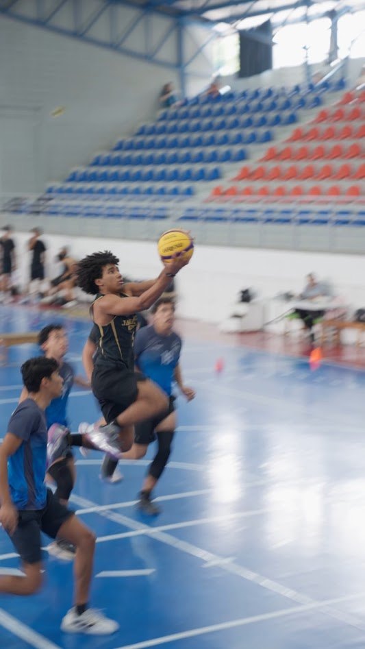 Basketball player driving to the basket mid-air