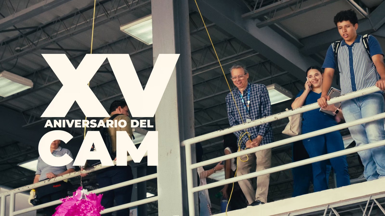 XV del CAM — crowd on a walkway above a piñata